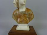 marble bust of a woman with a turban on a wooden base
