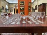 many wine glasses sitting on a table in a room