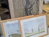 two framed pictures on a table next to each other