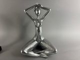 a close up of a statue of a woman with her hands on her hips