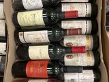 bottles of wine are in a cardboard box on a table