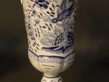 a blue and white vase with a bird on it