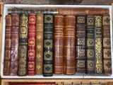 many old books in a wooden box on a shelf
