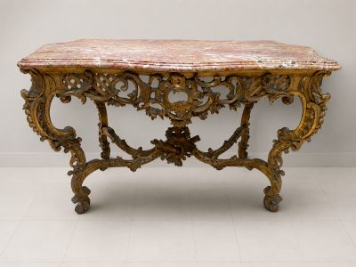 an antique console table with a marble top and ornate carvings