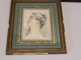 framed drawing of a woman ' s profile in a gold frame