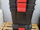 two black and red boxes stacked on top of each other on a pallet