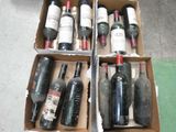 several bottles of wine are in a cardboard box on the floor