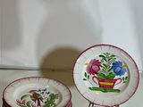 a stack of plates with flowers on them on a table