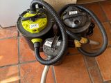 two vacuums sitting on the floor next to each other