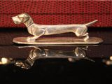 a silver dog figurine sitting on top of a table