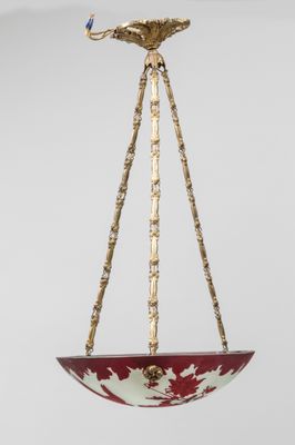 a close up of a red and white bowl hanging from a ceiling