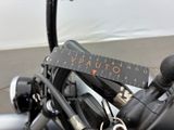 a measuring tape on the handlebars of a motorcycle