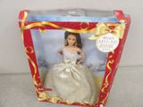 barbie doll in a box with a gold ribbon around the neck