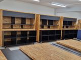 a room that has a bunch of wooden shelves in it