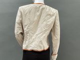 the back view of a mannequin wearing a beige jacket and black pants