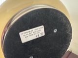 a yellow and black clock on a table in a room
