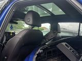 a blue car with a black seat and a blue seat cover