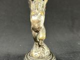 an antique bronze figurine of a bird on a pedestal
