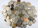 a pile of coins on a table with a white background