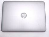 a silver laptop with a hp logo on the screen
