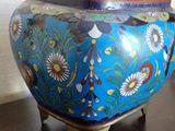 a blue vase sitting on top of a wooden table