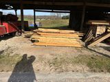 a man standing in front of a pile of wood