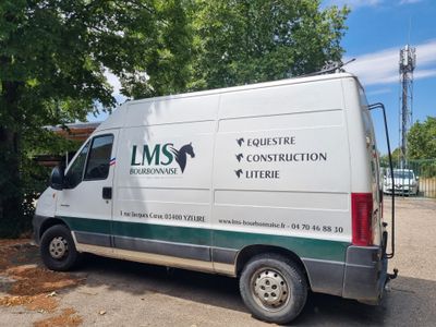 a white van that is parked in the parking lot