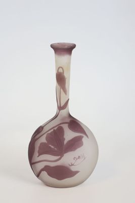 a vase with a bird on it sitting on a table