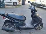 a scooter that is parked on the side of the street