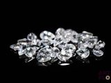 a pile of white diamonds on a black surface