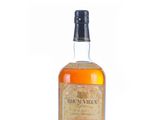 a bottle of brandy whiskey sitting on top of a white surface