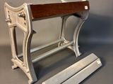 a wooden bench that is sitting on a gray surface