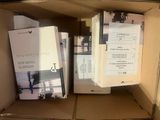 books in a cardboard box on top of a table next to a keyboard