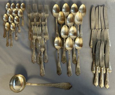 a lot of silver spoons and forks on the table