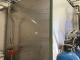 a large tank of water next to a blue tank