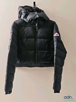 an image of a black jacket hanging on a hanger