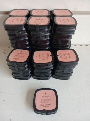 a pile of black and pink containers with pink labels on them