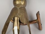 a bird that is sitting on top of a wooden pole