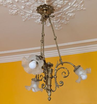 a chandelier hanging from the ceiling in a yellow room