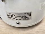 a close up of a white helmet on a wooden table