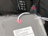 a black jacket with a white tag on it and a black jacket with a white tag attached to it