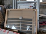 a pile of furniture in a room with a lot of windows