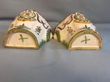 two pieces of pottery that are sitting next to each other