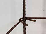 a close up of a piece of metal with a knot on it