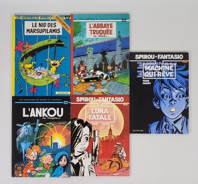 Plusieurs livres sont alignés sur une surface blanche devant un mur blanc.