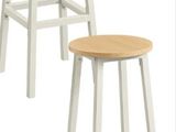 three white stools with wooden tops on a white background