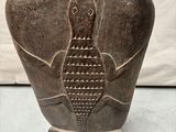 a person that is touching a vase with a fish on it