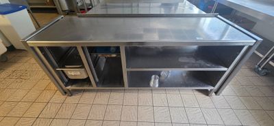 a stainless steel work table with a shelf on the side