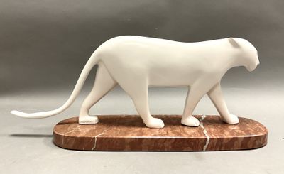 a white statue of a cat on a marble base