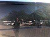 a man taking a picture of himself in the reflection of a bus
